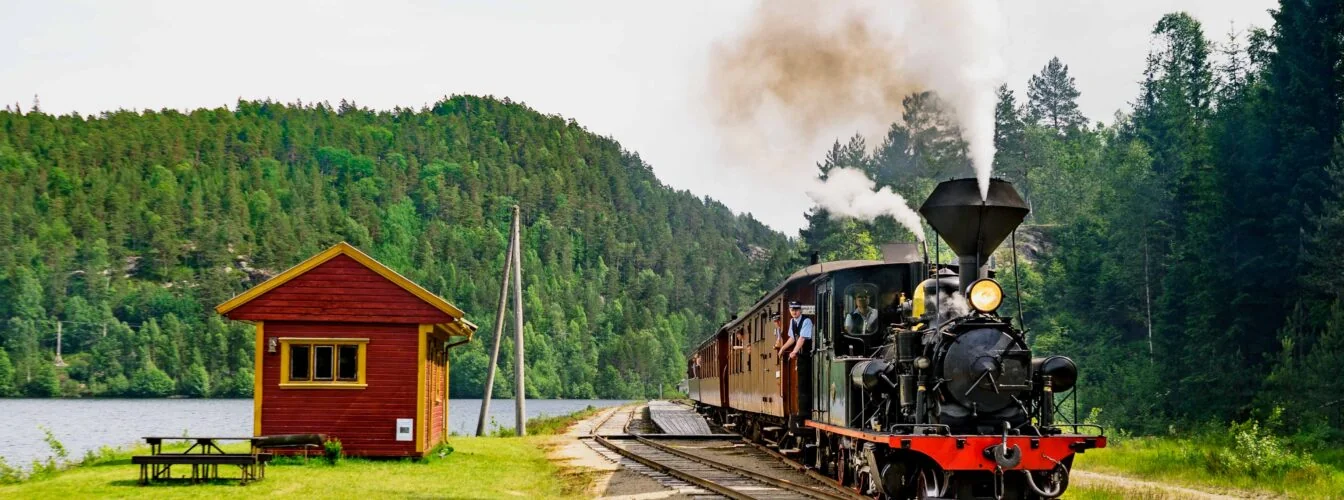 Bilde av damplokomotiv og gamle trevogner på Setesdalsbanen